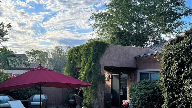 A backyard with a swimming pool, outdoor furniture, and a red umbrella. - Beautiful Home w/ Pool; Clean, Quiet, Secure - near Mayo Clinic; Hiking/Golfing (Scottsdale)