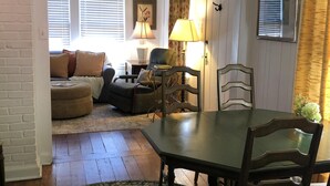 A cozy living room with a dining table, chairs, a sofa, and a patterned rug. - Bungalow located in downtown Tryon, N.C.  (Tryon)