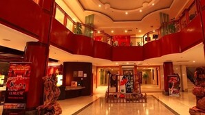 A hotel lobby with a central reception desk, multiple levels with balconies, and a modern architectural design. - Songling Hotel (Suzhou)