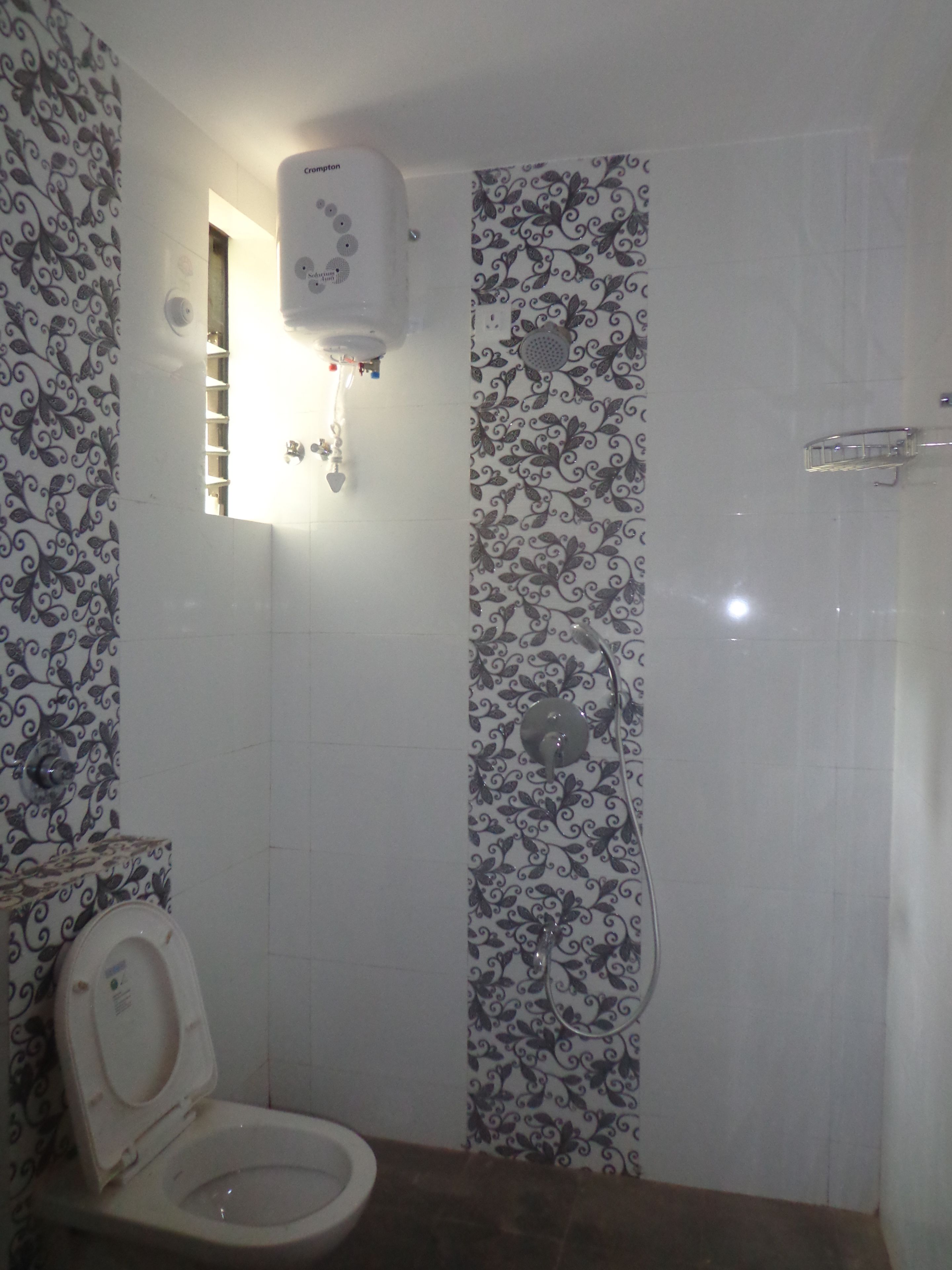 A bathroom with a toilet, a shower, and a wall-mounted water heater.