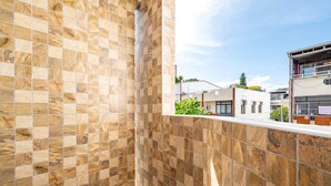 A tiled wall with a view of buildings in the background. - Taitung Hope castle (Taitung)