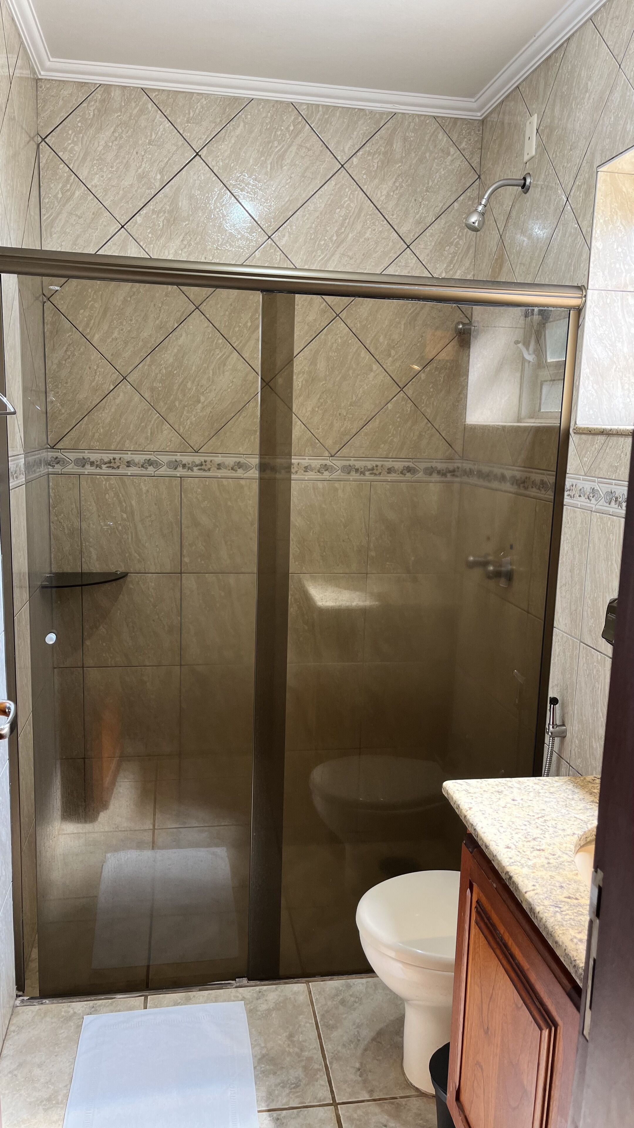 deluxe triple room | bathroom | shower, towels, soap, toilet paper