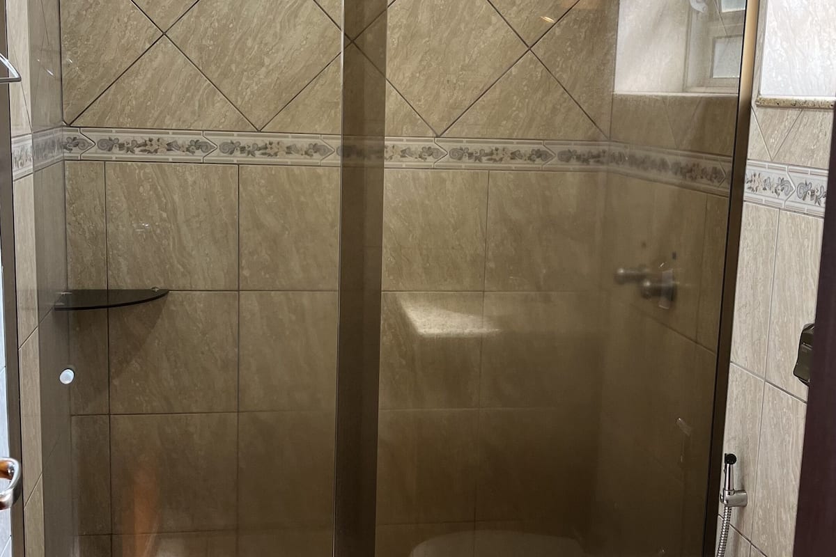 deluxe triple room | bathroom | shower, towels, soap, toilet paper