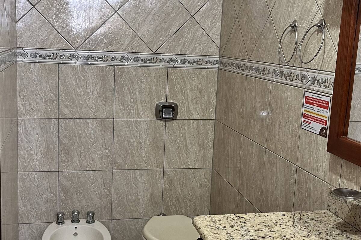deluxe quadruple room | bathroom | shower, towels, soap, toilet paper