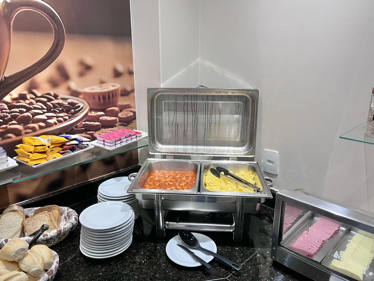 A buffet setup with various food items and utensils.