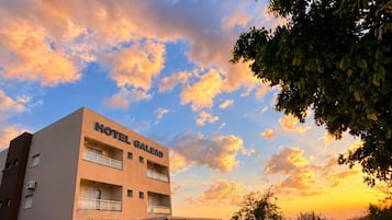 A hotel building with a sign reading 'HOTEL GALEAD' and a covered entrance.
