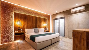 A modern bedroom with a large bed, wooden paneling, and a built-in wardrobe. - The Borough Lagos (Lekki)