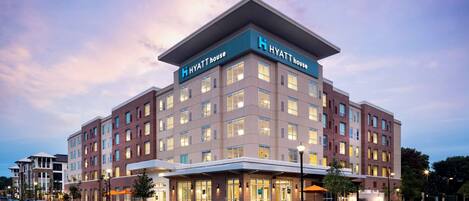 A multi-story hotel with a prominent 'Hyatt House' sign, large windows, and a flat roof.