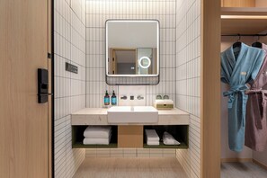 A modern bathroom with a large mirror, a sink, and a towel rack. - Atwell Suites Shanghai Wuning by IHG (Shanghai)