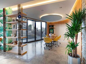 A modern office space with a conference table, yellow chairs, a plant, and a decorative shelf with various items. - ibis Styles Istanbul Atasehir (Istanbul)