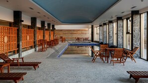 A spacious indoor area with a pool table, wooden lounge chairs, and a seating area with tables and chairs. - Taj Theog Resort & Spa, Shimla (Theog)