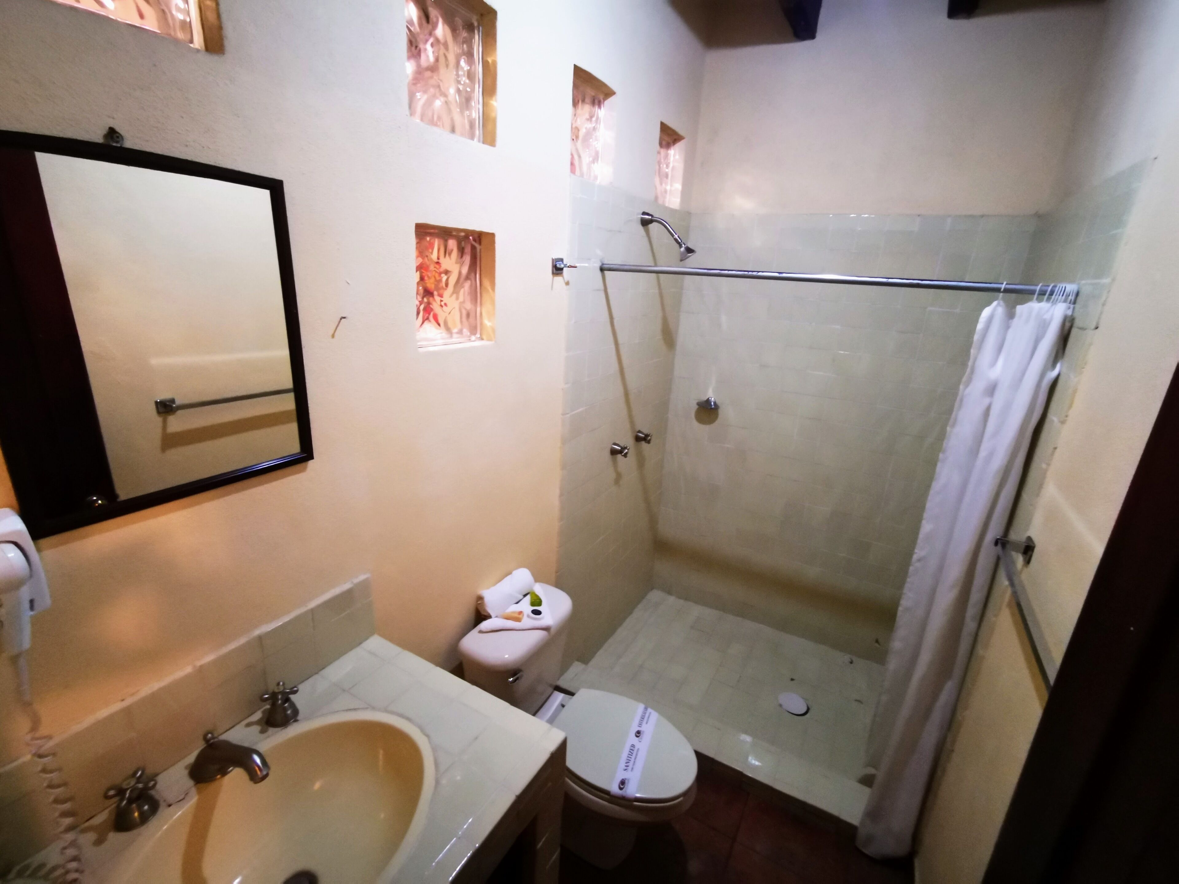A bathroom with a sink, toilet, and shower.
