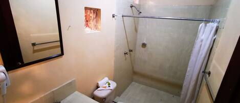 A bathroom with a sink, toilet, and shower.