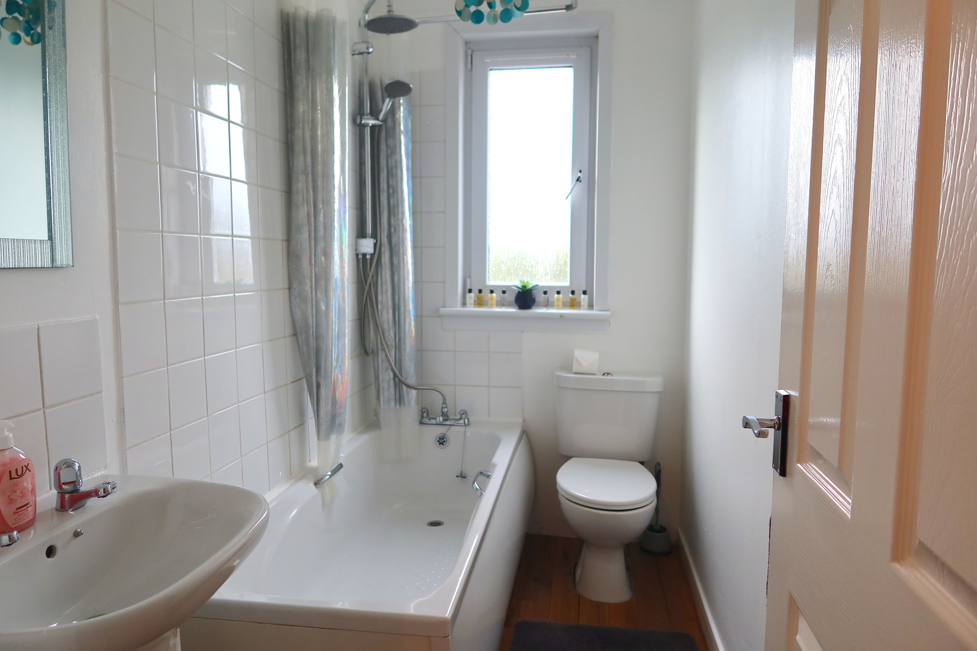 Combined shower/bathtub, hair dryer, bathrobes, slippers