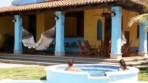 A pool area with a hot tub, hammocks, and wooden chairs. - Exclusive Beachfront Large Spanish Estate for up to 30 people, WiFi (Pochomil, San Rafael del Sur)