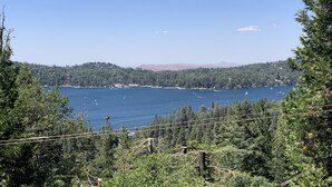 A lake surrounded by dense forest and hills.