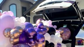 A vehicle with a trunk open, revealing a collection of balloons.