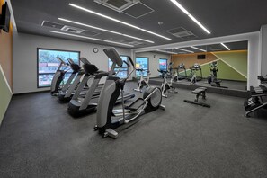 A gym with treadmills, ellipticals, and a bench. - City Express Plus by Marriott Tijuana (Tijuana)