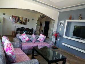 Apartment, 3 Bedrooms | Living area | Flat-screen TV