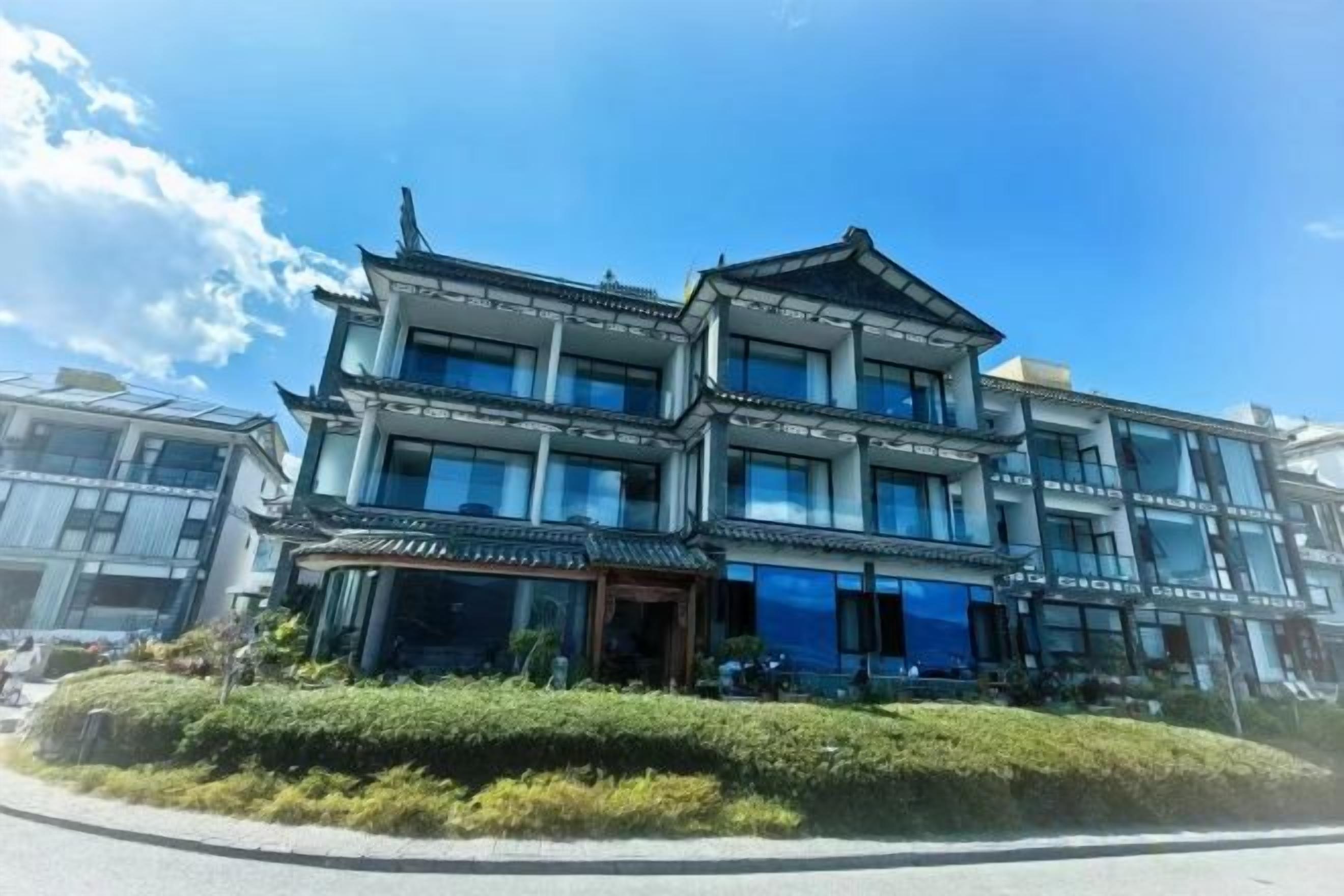 A multi-story building with a traditional architectural style, featuring a prominent entrance and large windows.