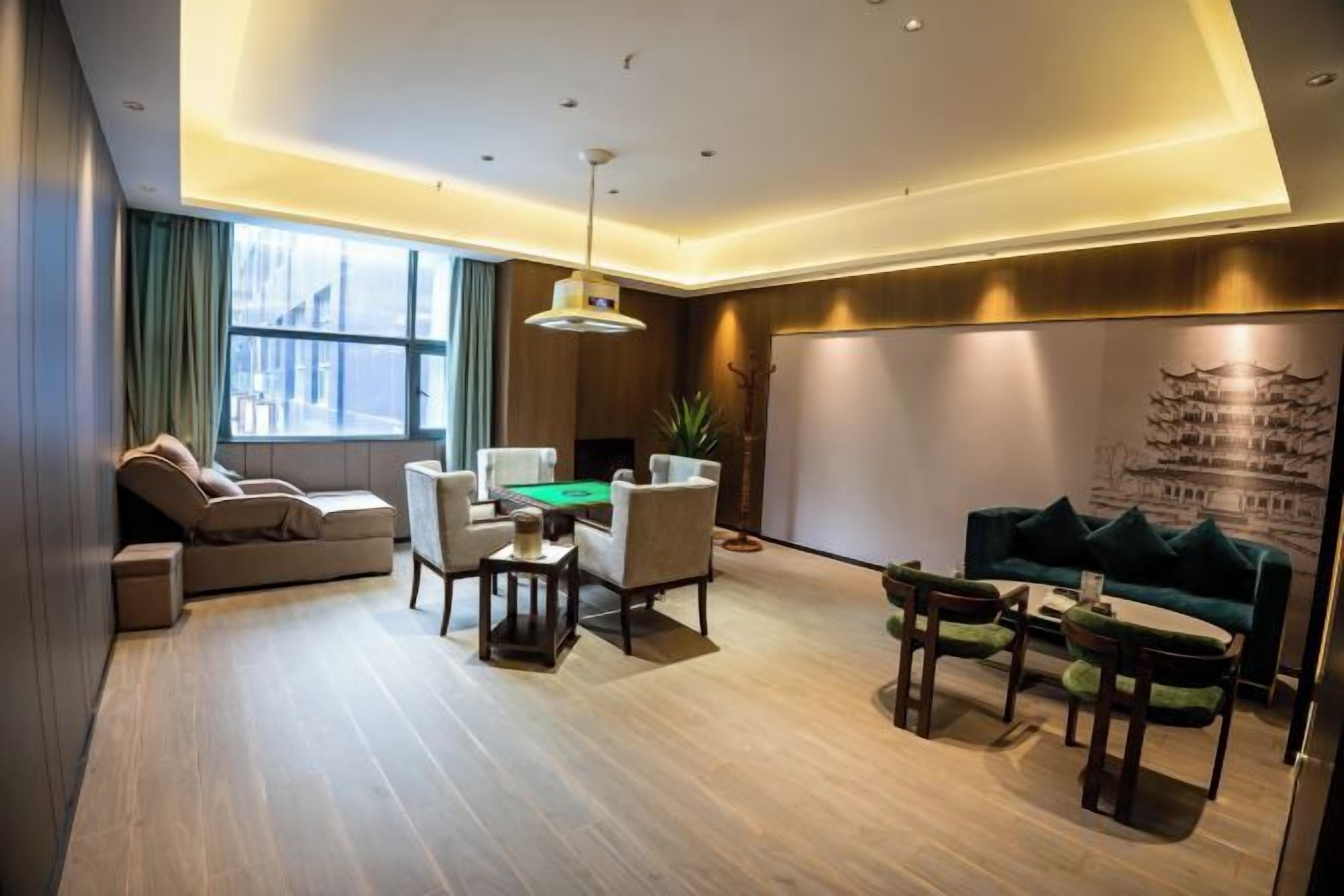 A modern living room with a sofa, a coffee table, and a dining table with chairs.