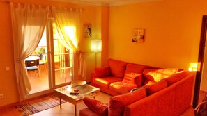 Large lounge leading to the balcony for relaxing after a hard day on the beach. 