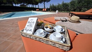 A poolside setting with a tray of breakfast items, including coffee cups and a sign reading "Meet Me at the Museum". - Luxury Villa for 16 with Private Pool near Rome - Santa Cristina Estate (Magliano Sabina)