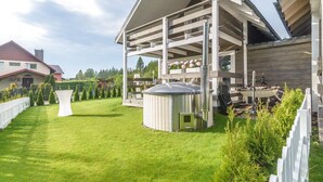 A modern house with a large deck, a satellite dish, and a small shed. - Woodhouse Resort Dobrogoszcz (Dobrogoszcz)