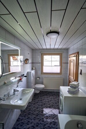 Bathtub, hair dryer, towels, soap