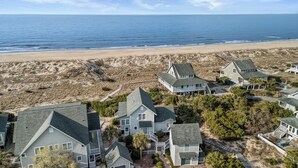 A coastal residential area with houses, a beach, and a clear view of the ocean. - Welcome to BIS BALD!, your Oceanfront Escape on BHI! (Bald Head Island)