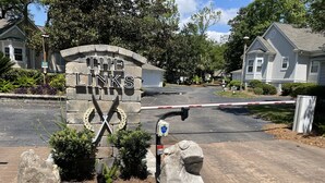 A gated entrance with a sign reading "THE LINKS" and a stone wall.