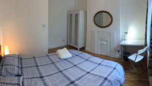 A bedroom with a bed, a desk, and a chair. - The White House 7 DOUBLE BED HOUSE FULLY-EQUIPPED (London)