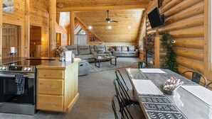A log cabin interior with a kitchen, dining area, and living room. - Bear Tracks - 20 Miles to Yellowstone - Air Condition - Wifi (Island Park)