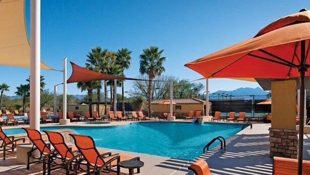 A pool area with lounge chairs and umbrellas, surrounded by palm trees and a mountain view. - Golf ... Bird Watching, Biking, Hiking, Sunsets, Star Gazing ... Oh, great Golf (Green Valley)