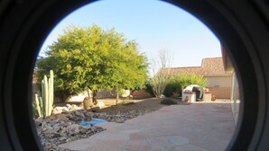 A stone patio with a cactus garden, a small water feature, and a building with a tiled roof. - Golf ... Bird Watching, Biking, Hiking, Sunsets, Star Gazing ... Oh, great Golf (Green Valley)
