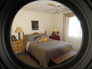 A bedroom with a bed, bedside tables, a nightstand, a lamp, a ceiling fan, and a window with curtains. - Golf ... Bird Watching, Biking, Hiking, Sunsets, Star Gazing ... Oh, great Golf (Green Valley)