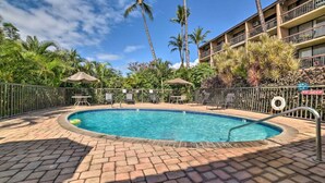 A swimming pool with a brick deck, surrounded by palm trees and a fence. - Maui Vista #2110 - Ground Floor! REDUCED RATES! BEDROOM AC, near beach!! (Kihei)