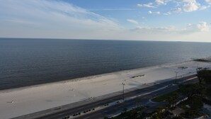 A coastal road with a beach and ocean. - Top Floor Legacy Penthouse / Stunning Gulf Views / Walk to Beach, Pools & more! (Gulfport)