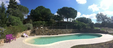 Alberca al aire libre y camastros