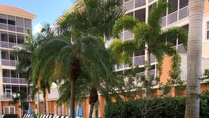 A hot tub area with lounge chairs and a stone-tiled deck. - Naples Vanderbilt Beach-beautiful Updated-walk to the beach (Naples)