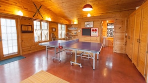 A wooden interior with a ping pong table, windows, and a sink. - Fantastic House In Grand Marais! Walking Distance To Downtown! (Grand Marais)