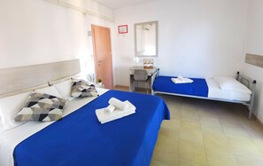 A hotel room with two beds, a desk, a chair, and a mirror. - Hotel Bellini (Riccione)