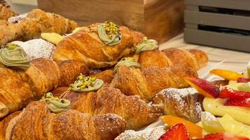 A variety of pastries and fruits on a table.