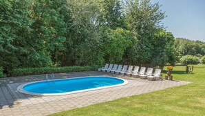 A swimming pool with a paved deck and lounge chairs. - Beautiful apartment in Simpelveld (Simpelveld)