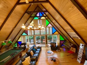 A cozy, wooden interior with a pool table, leather sofa, and a dining area. - YOUR PRIVATE POCONO ESCAPE: LAKE, SLOPES, HOT TUB & HOME YOU WON’T WANT TO LEAVE (White Haven TA)