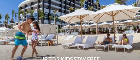 On the beach, sun loungers, beach umbrellas, beach towels