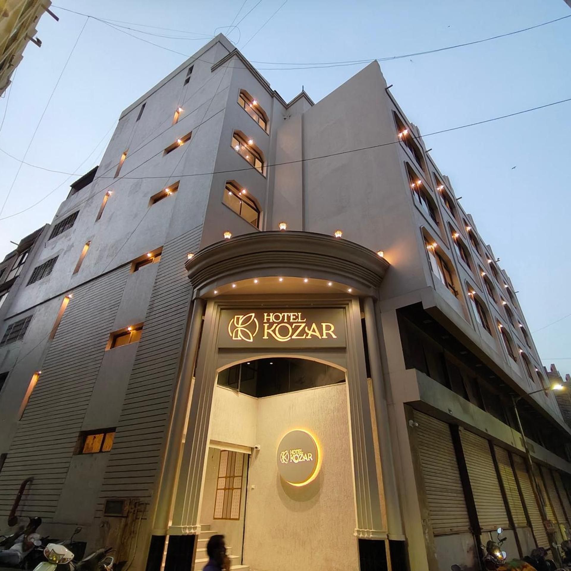 A multi-story hotel with a prominent entrance featuring the name 'HOTEL KOZAR'.