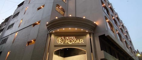 A multi-story hotel with a prominent entrance featuring the name 'HOTEL KOZAR'.