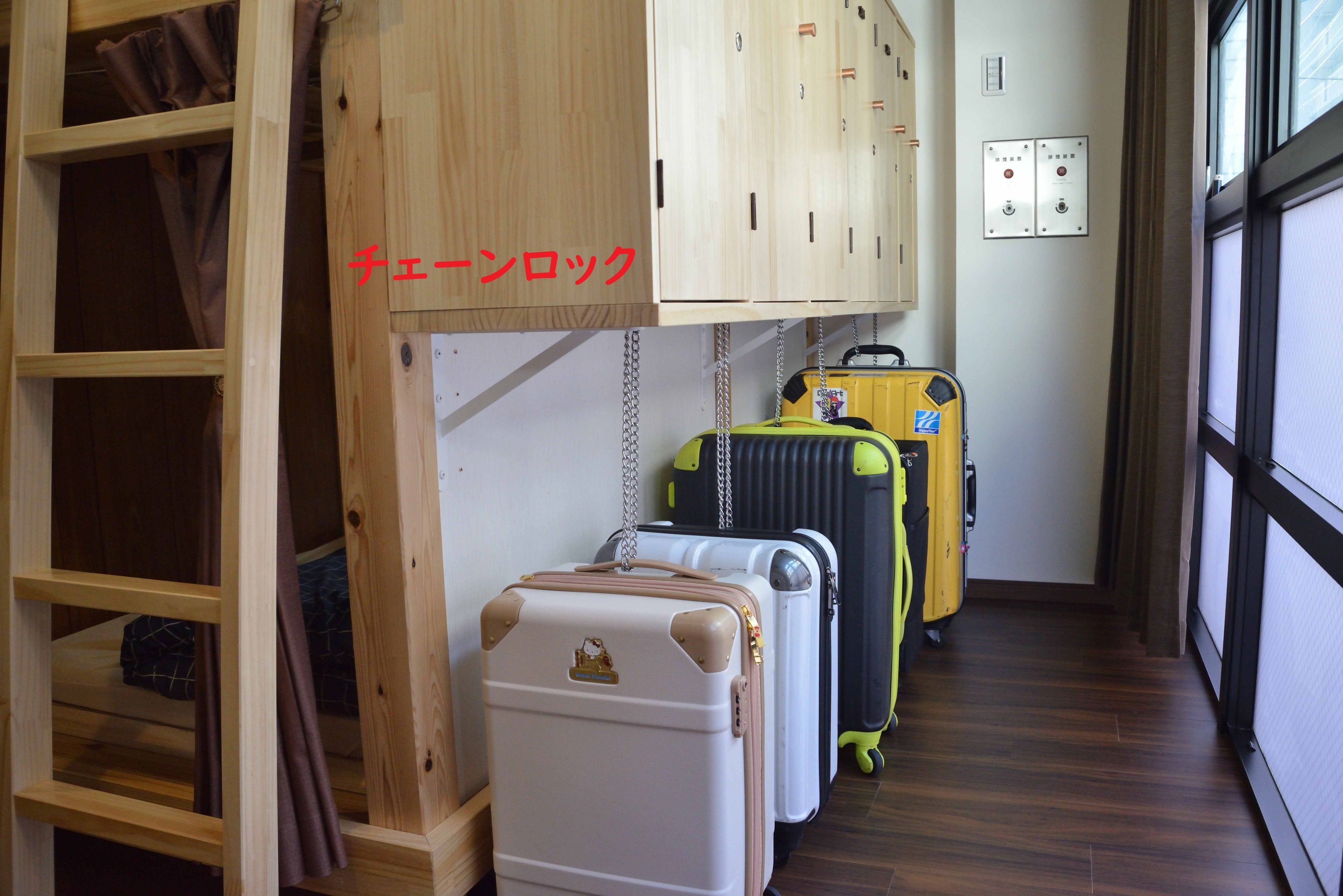 A room with wooden cabinets, a ladder, and several suitcases.