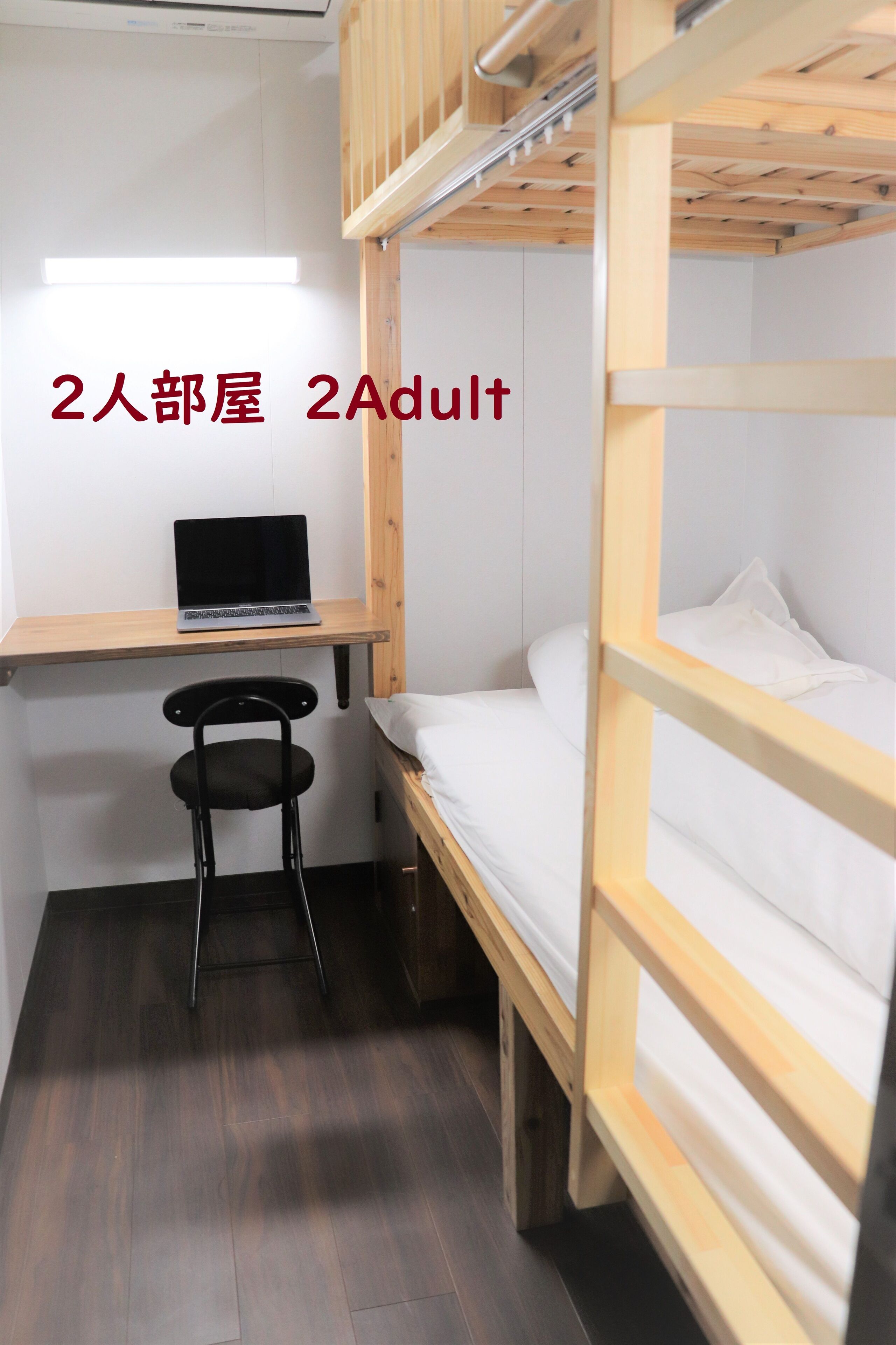 Dormitorio para dos personas con escritorio, silla y literas.